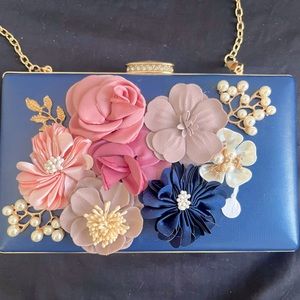 Blue Clutch With Floral Embroidery And Gold Toned Crossbody Chain